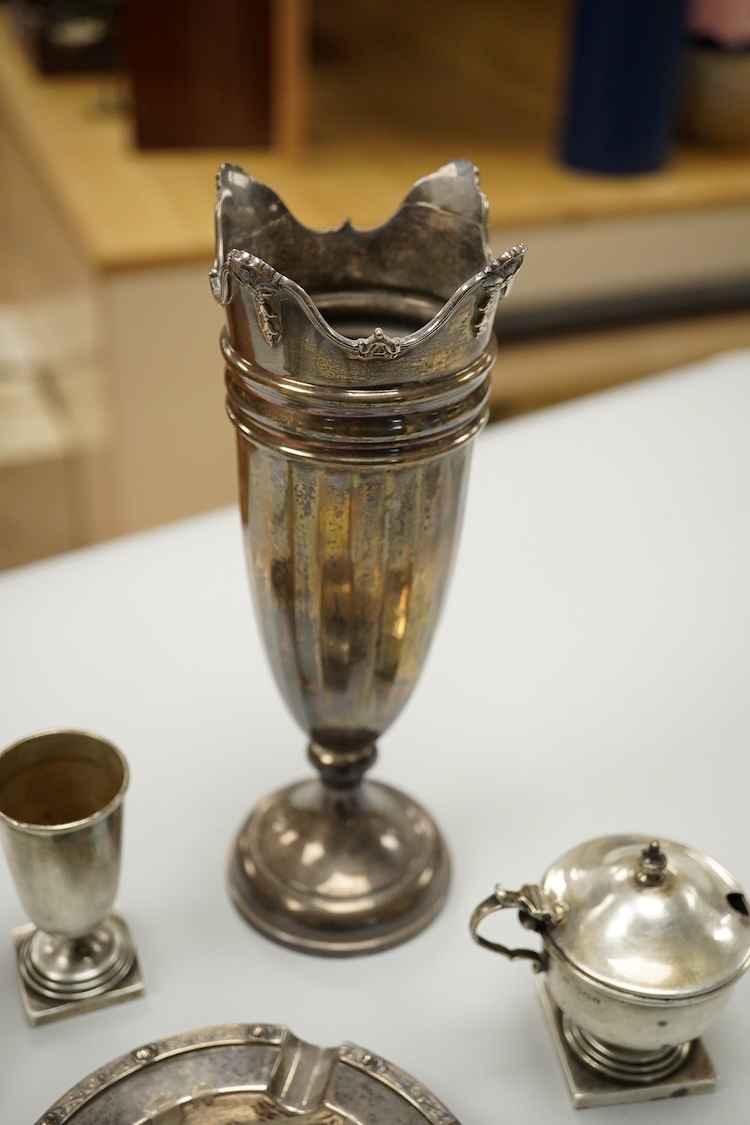 An Elizabeth II silver mounted vase with wavy border, Adie Brothers, Birmingham, 1955, weighted, 20.4cm, a silver mounted glass swan bonbon dish, a George V silver three piece condiment set, a silver mounted glass toilet